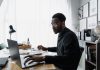 Public Interest Score Calculators in South Africa: Common Mistakes and How to Avoid Them Professional using a laptop while reviewing information related to a Public Interest Score Calculator South Africa