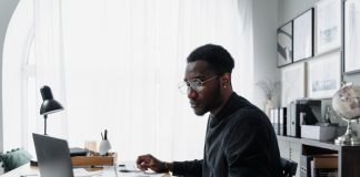 Public Interest Score Calculators in South Africa: Common Mistakes and How to Avoid Them Professional using a laptop while reviewing information related to a Public Interest Score Calculator South Africa